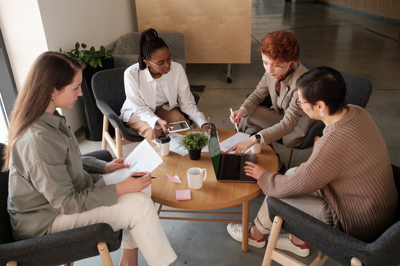 A diverse group of professionals engaged in a collaborative meeting at a modern office table.